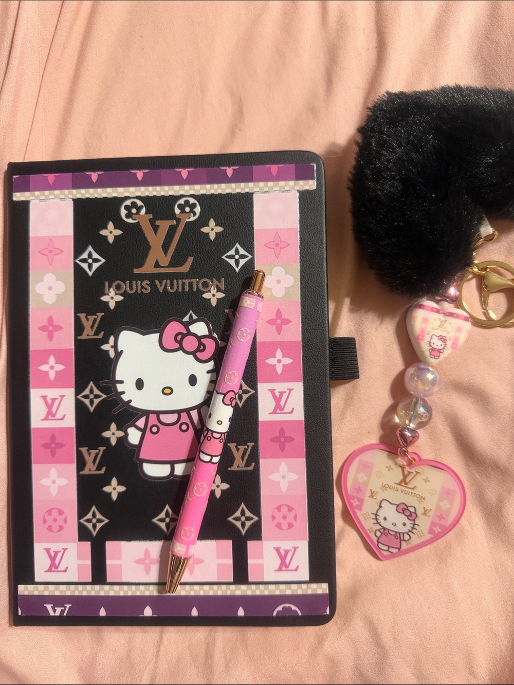 Black & pink journal with matching pen and fluffy heart keychain with charm.
